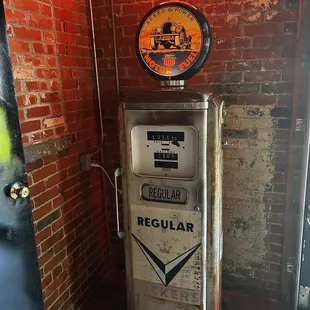 an old gas pump and a neon sign