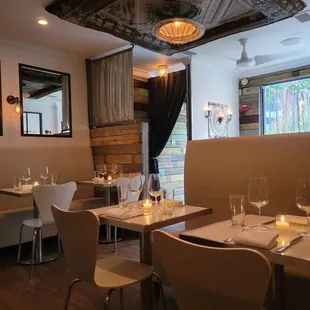 a dining room with white tables and white chairs