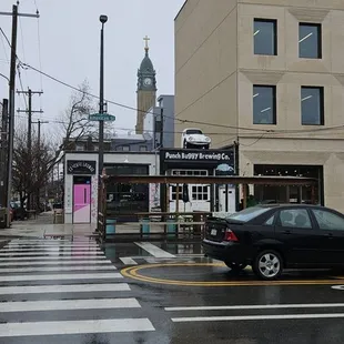 a black car driving down the street