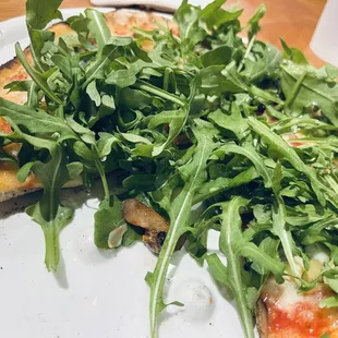 Create-your-own with Margherita base, artichoke, mushrooms, and arugula after bake. Delicious!
