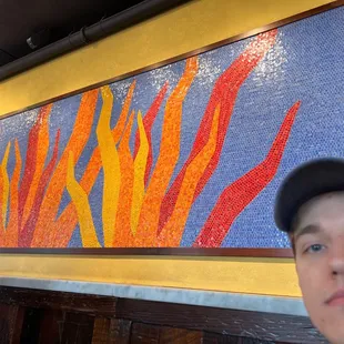 two men in front of a painting