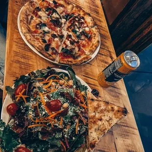 two plates of pizza and a salad