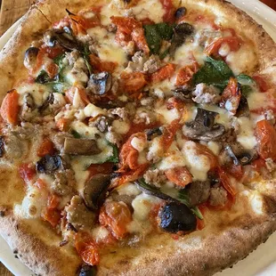 Neapolitan pizza with tomatoes, mushrooms, and sausage!
