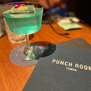 a drink and menu on a table