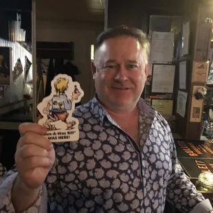a man holding a pint of beer