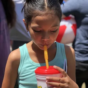 a young girl drinking a drink