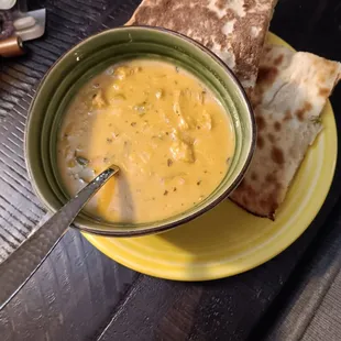 Half of the serving of Mulligatawny soup and an order Aloo Naan.