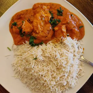 a plate of food with rice and chicken