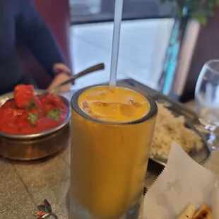 a glass of orange juice on a table