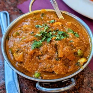 a bowl of indian food on a table