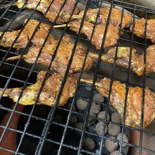 a barbecue grill with meat on it