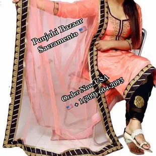 a woman sitting in a chair holding a sari