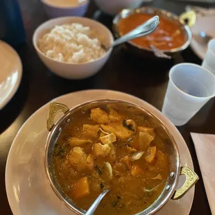 a bowl of soup and rice on a table