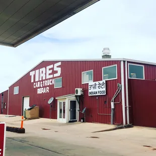 a red building with a sign for tires