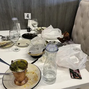 Our empty plates and take home boxes! Loved that the dal was served in the copper pot!