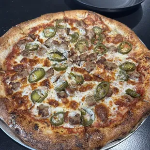 Cheese pizza with sausage and jalapeño