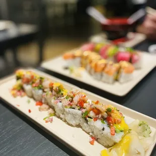 two plates of sushi on a table