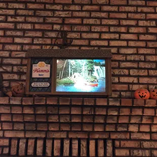 a tv on a brick wall