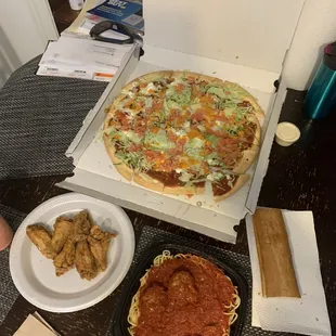 Taco pizza, wings, garlic bread, and spaghetti