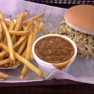 Smoked pork platter with fries and baked beans.