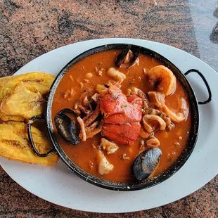 a bowl of seafood and bread