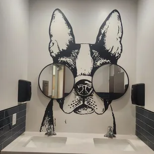 a dog's face in a bathroom mirror