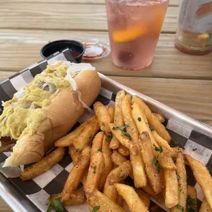 The Boston Terrier and fries with the drink special in the background Peachy  Spritz.