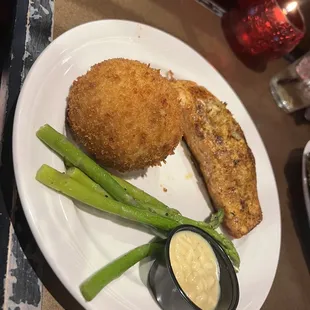 Crab stuffed salmon with fried loaded potato cake and asparagus