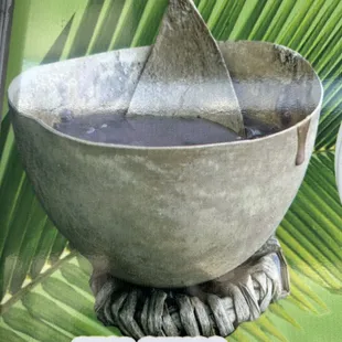 a bowl with a shark fin sticking out of it