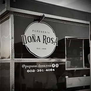 a black and white photo of a food truck