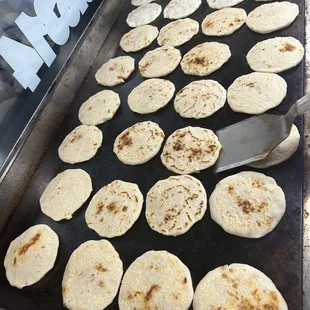 a tray of pupusas being prepared
