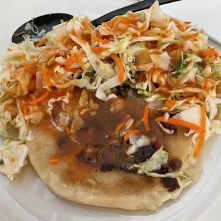 Jalapeño pupusa with cabbage and red sauce