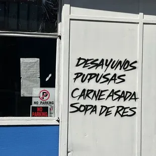 The side of the building listing what's on the menu.