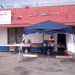 a dog sitting under a tent
