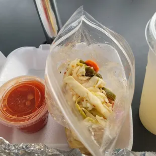 Hot sauce &quot;broth&quot; was bland. Pickled slaw was nice. Guanabana (soursop) drink on left from the Yelp check-in offer.