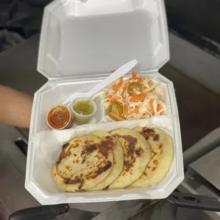 a person holding a tray of food