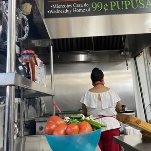 a woman preparing food in a kitchen