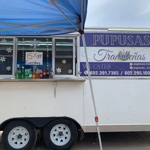 a food truck with a blue canopy