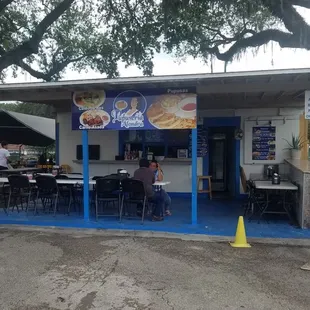 a dog sitting in front of a restaurant
