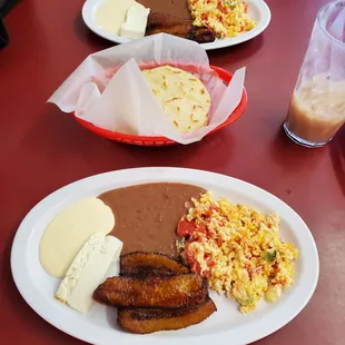 Breakfast: Huevos Revueltos, beans, cream, cheese, and plantains. Comes with 2 handmade tortillas.