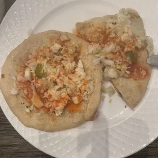 Pupusas topped with curtido and salsa