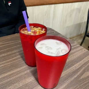 wo cups of milk and a purple straw