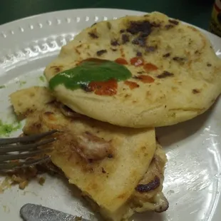 Bean &amp; Cheese pupusa with hot sauce.