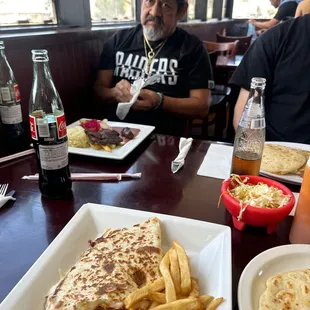a man sitting at a table with food