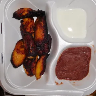 Fried sweet plantains, refried beans, homemade sour cream.