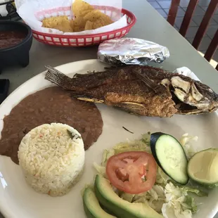 Fried tilapia, refried beans, rice, salad, flour tortillas. The fish is sprinkled with a salt crystal that really adds to the flavor.