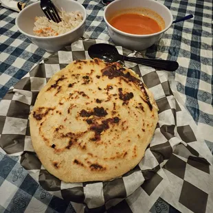 two bowls of soup and a flatbread