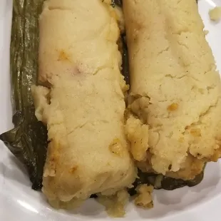 Chicken corn tamale steamed in banana leaves.