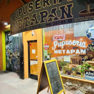 Signage is brightly lit and colored.