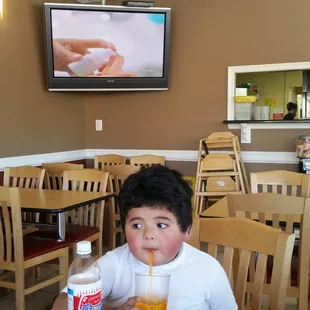 My nephew enjoying his Cola champagne while waiting on his pupusas. Place is clean, friendly, reasonable prices, and good food!